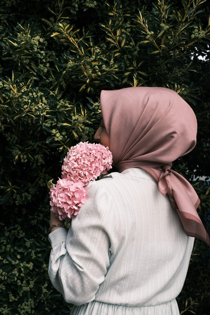 Hijabi Woman Hugging Bouquet of Hydrangeas