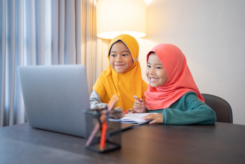 Muslim Children Wearing Head Scarf Smiling While Using Laptop Computer